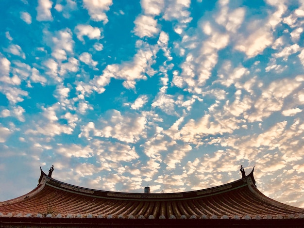 High section of temple building against cloudy sky