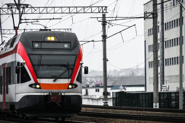 A high-speed passenger train travels along the railway lines in the city