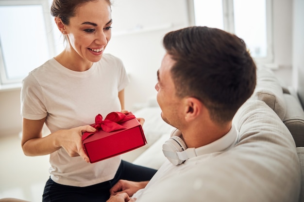 High-spirited wife congratulating her husband on his birthday