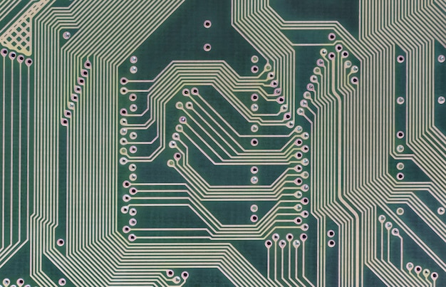High tech technology geometric background with back side of circuit board. Close up of a circuit board. Top view.