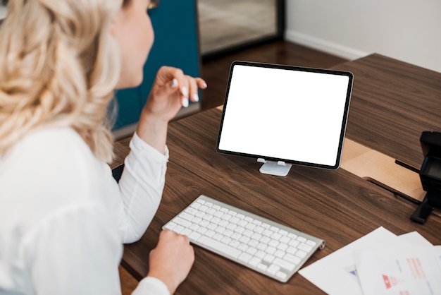 High view business woman looking at a copy space digital tablet