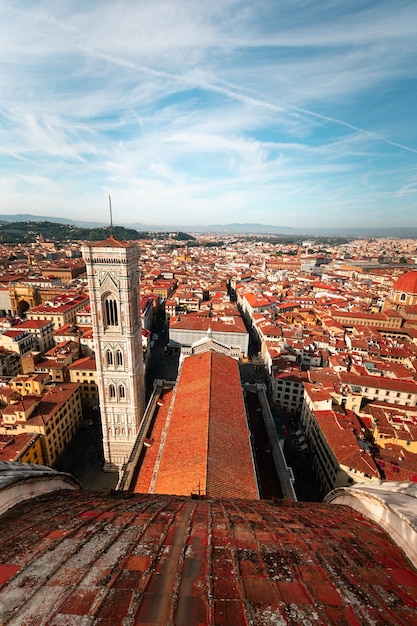 High view from Santa Maria del Fiore cathedral with a wide view of the Giotto's Bell Tower and the city of Firenze, Tuscany, Italy.