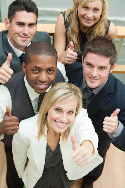 High view of happy business team with thumbs up