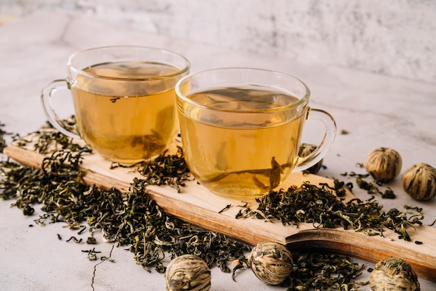 High view set of cups and dried tea herbs