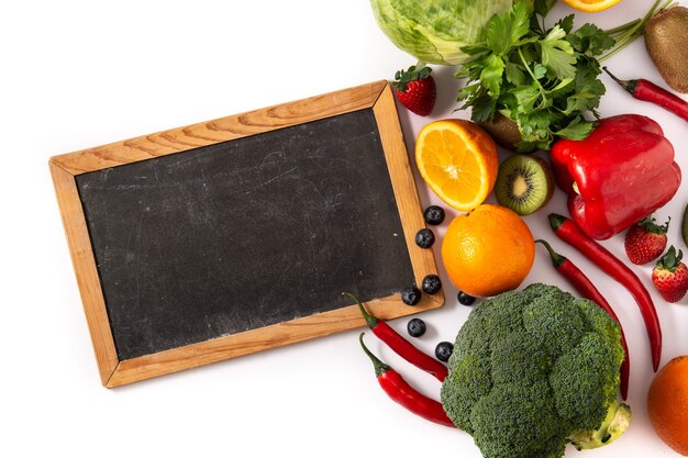 High in vitamin C food and blackboard  isolated on white background