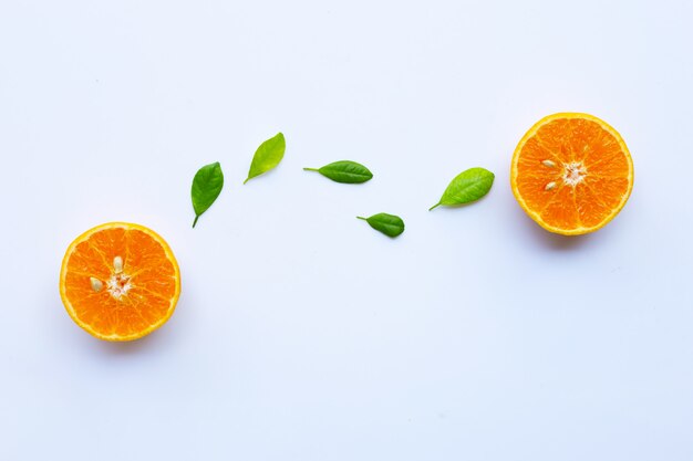 High vitamin C. Fresh orange citrus fruit with leaves isolated on white.