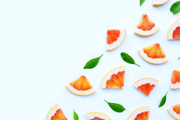 High vitamin C. Juicy grapefruit slices on white wall.