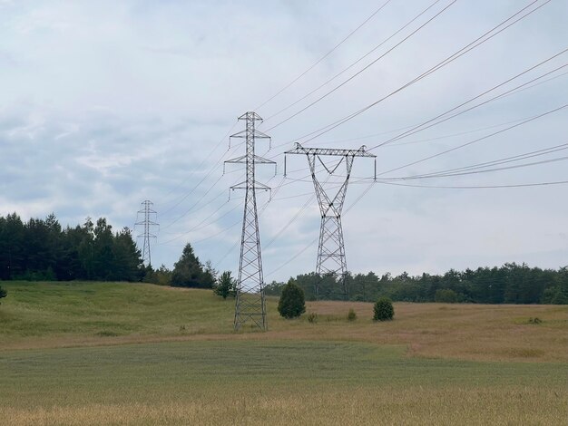 High voltage electric pole in the Alpine scenery High voltage electric pole in mountains valley