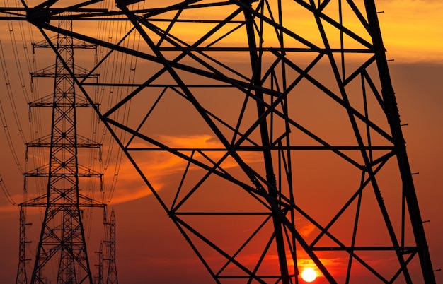 High voltage electric pole and transmission lines in the evening