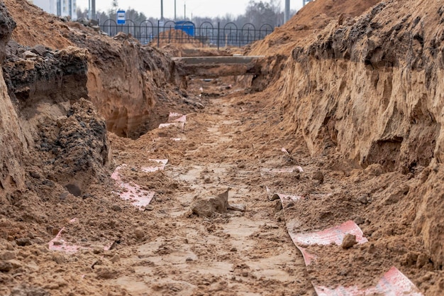 High voltage electrical cable Highvoltage cable in a trench covered with a special protective protective tape High voltage electricity for supplying buildings