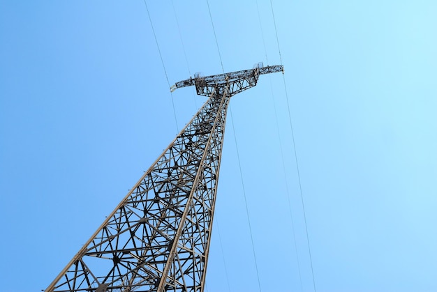 High voltage Electricity pylon against blue sky