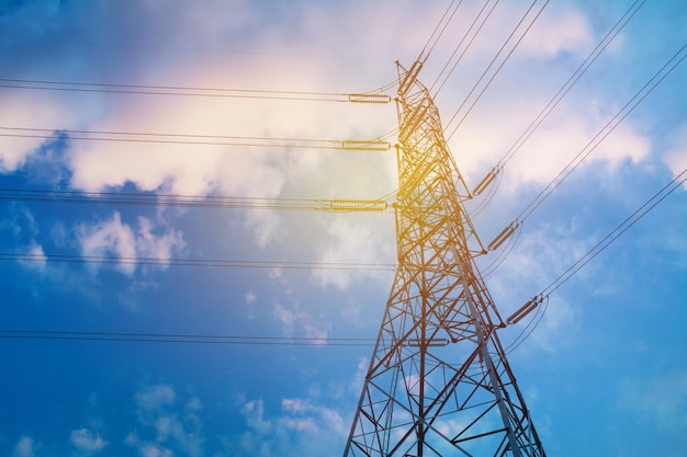 High voltage pole on blue sky background. High voltage tower.