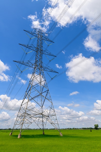 High voltage pole on wihte cloudy and blue