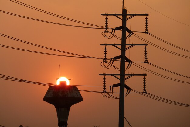 High voltage post at sunset