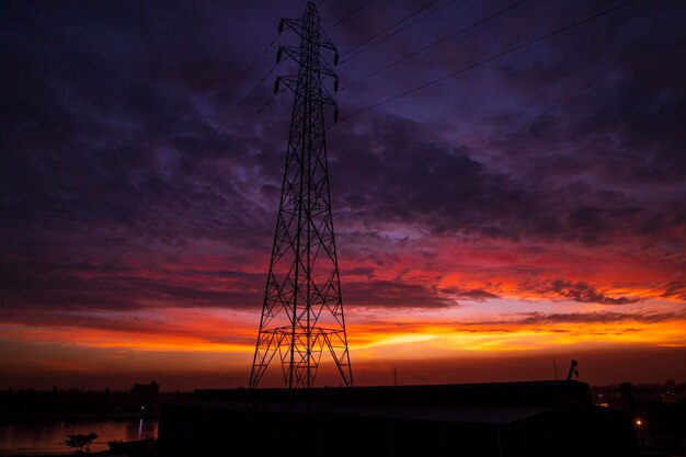 High voltage power line tower with beautiful sky at sunset stock photo