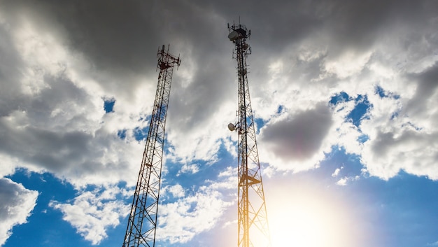 High voltage power lines and eletric towers at sunset. Electricity distribution station concept image.