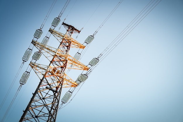 A high voltage power pylons against blue sky