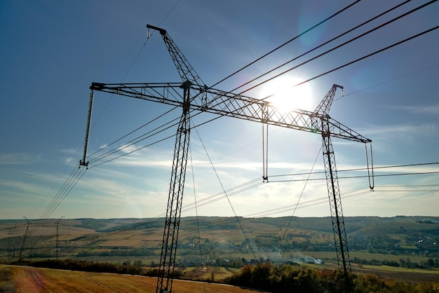 High voltage tower with electric power lines transfening electrical energy through cable wires