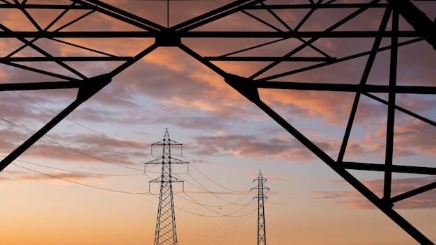 High voltage towers pylon on sunset