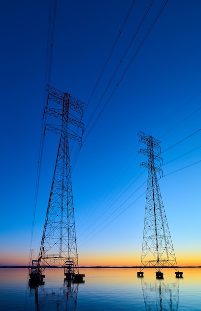 Photo high voltage transmission lines crossing wheeler lake at dusk near athens al