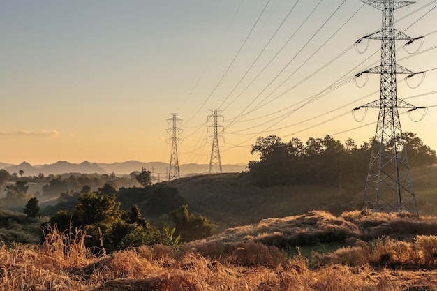 High voltage transmission tower at sunset