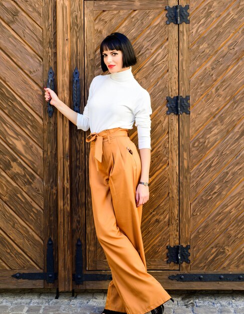 High waisted pants fashion trend High waisted trousers Woman attractive brunette wear fashionable clothes Femininity and emphasize feminine figure Girl wear loose high waisted pants Fashion shop