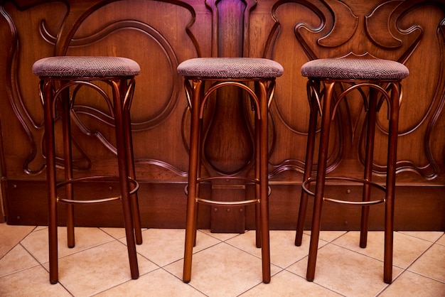 High wooden bar stools stand near the bar counter.