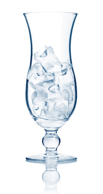 Highball cocktail glass full of ice cubes isolated