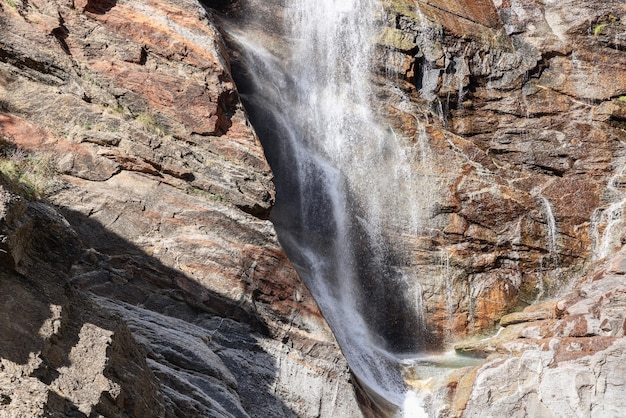 Highcontrast closeup of foamy Lillaz Waterfall over granite rapids Aosta Valley Italy