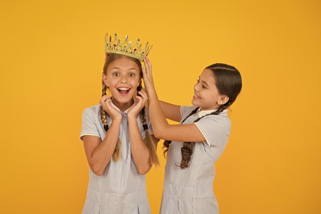 Higher standard vintage girls in gold crown motivation to be the best small egoist girls imagine they princess success reward happy childhood frienship prom queen retro look of selfish kids