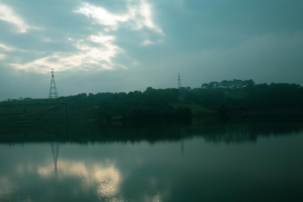 highland with green hills and town near river bank Dak RTih with  cloudy sky in Gia Nghia Daknong