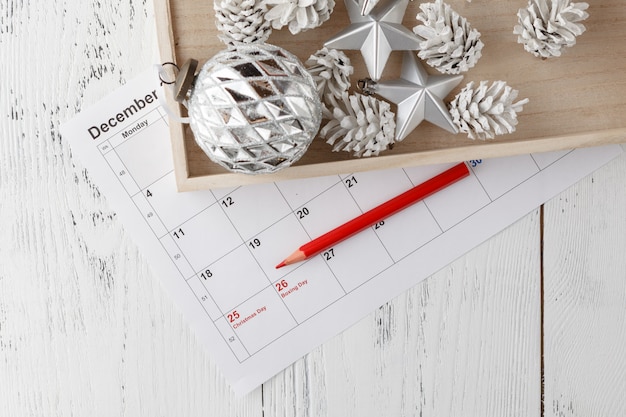 Highlighting Christmas date on calendar with Christmas ornaments