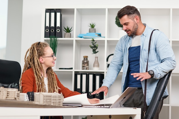 Highly qualified purposeful male engineer and female designer working with the layout of future