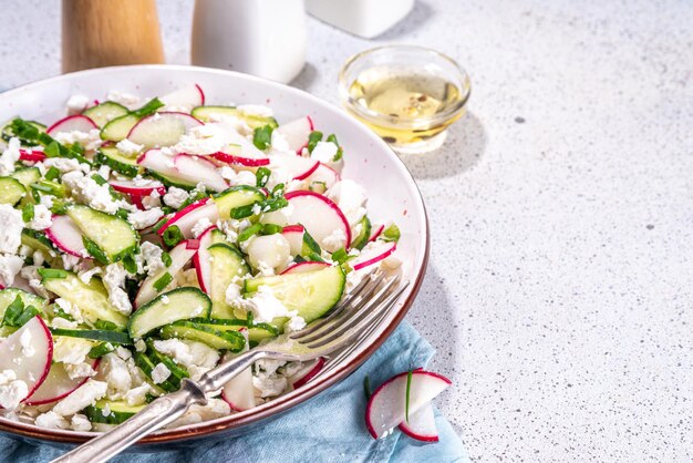 Highprotein diet vegetable salad with cottage cheese Fresh curd cheese salad with cucumbers and radish copy space