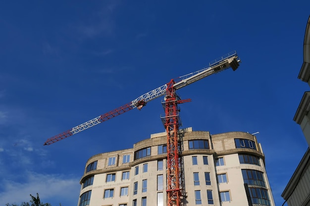 Highrise construction crane against the blue sky