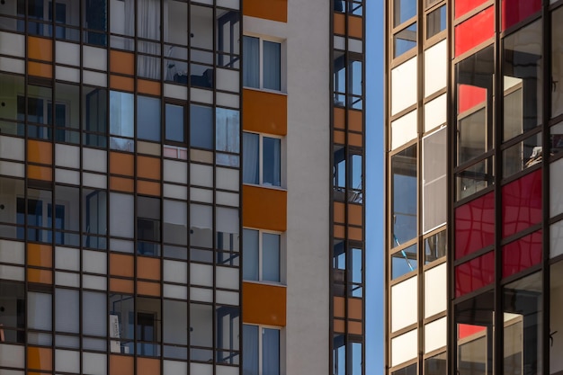 Highrise residential apartment buildings of dense development with a large number of windows and ba