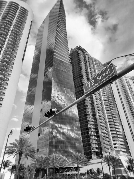 Highrisers on cloudy sky in city street of Sunny Isles USA