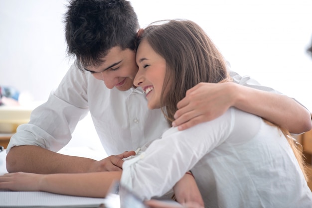 Highschool boy hugging female classmate