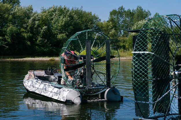 Highspeed riding in an airboat on the river on a summer day with splashes and waves