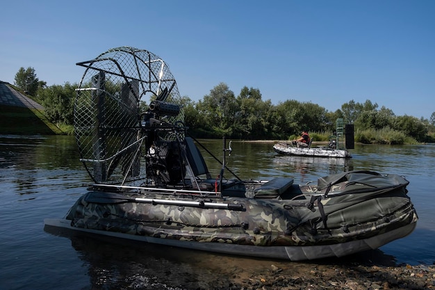 Highspeed riding in an airboat on the river on a summer day with splashes and waves