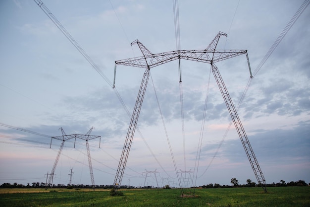 Highvoltage power lines and high voltage electric transmission tower in a twilight