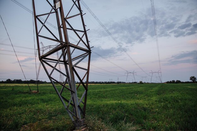 Highvoltage power lines and high voltage electric transmission tower in a twilight