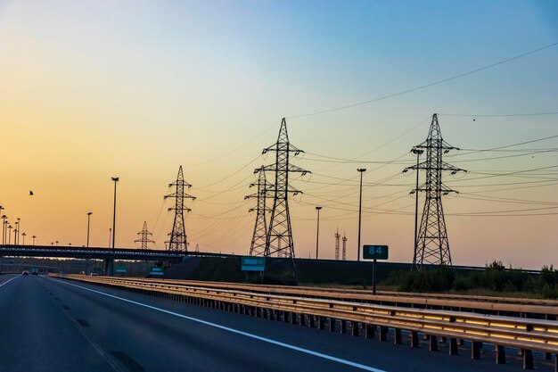 Highway In Bright Sunlight Power Line Illuminated By The Suna Beautiful Landscape In The Golden Hour