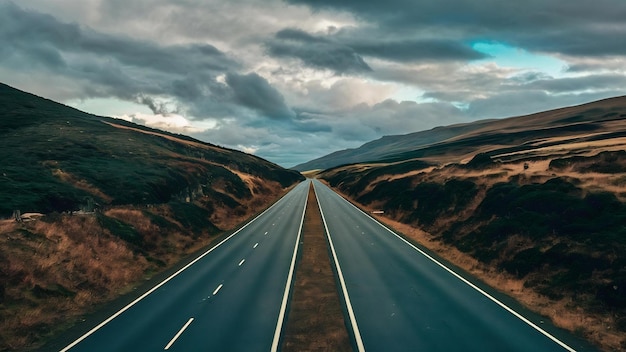 Highway surrounded by hills under the cloudy sky