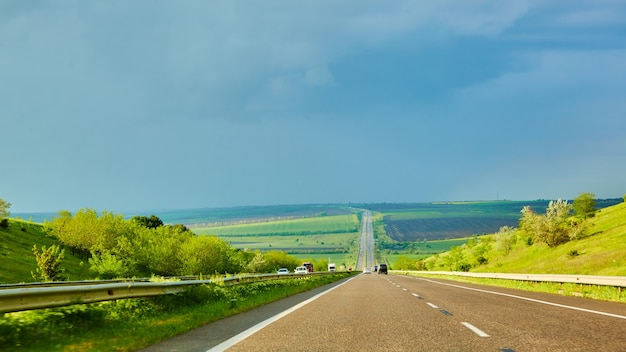 The highway traffic in sunset before the thunderstorm.