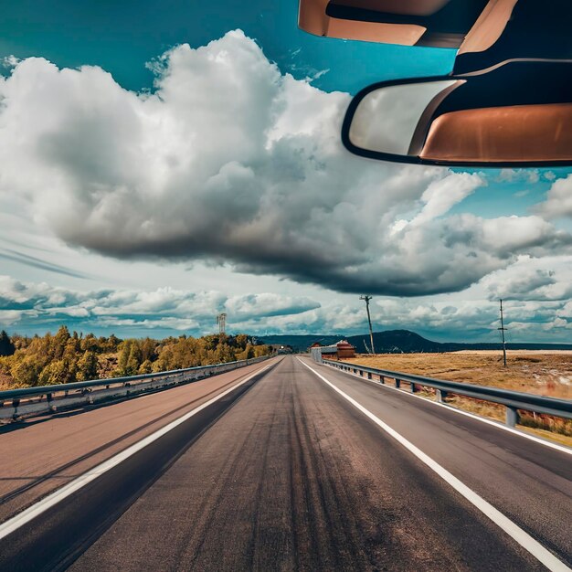 Highway with cloudy sky in summer View of the road through the windscreen