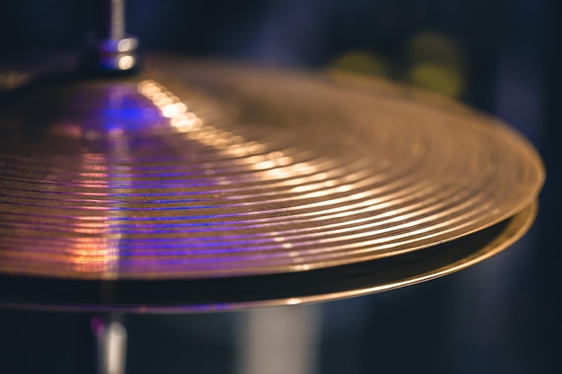 Hihat closeup of plates with drumsticks on a background of colored lanterns