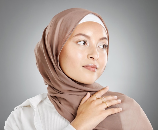 Hijab woman beauty and skincare for arab muslim female wearing a scarf makeup and cosmetics on grey studio background Islam fashion and skin care with trendy Muslimah wearing ring accessories