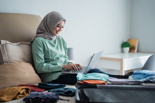 Hijab woman checking departure schedules via online application