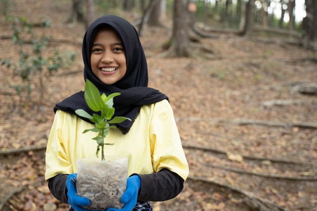 Hijab woman with new tree